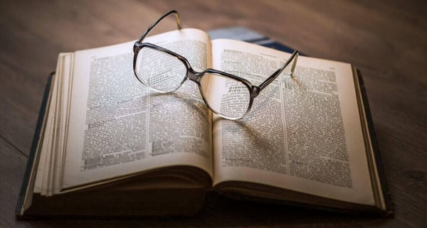 Bill Gates books: Open book with a pair of glasses