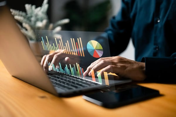 Private equity consulting: Laptop with colourful holographic charts