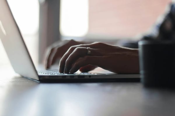 Consulting Exit: Hände tippen auf einem Laptop