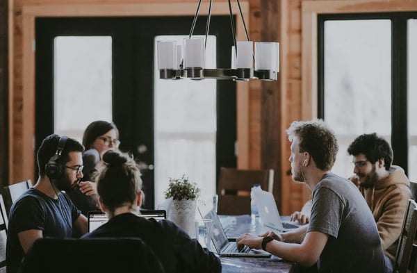 QHAR principle: Team at laptops in an open-plan office