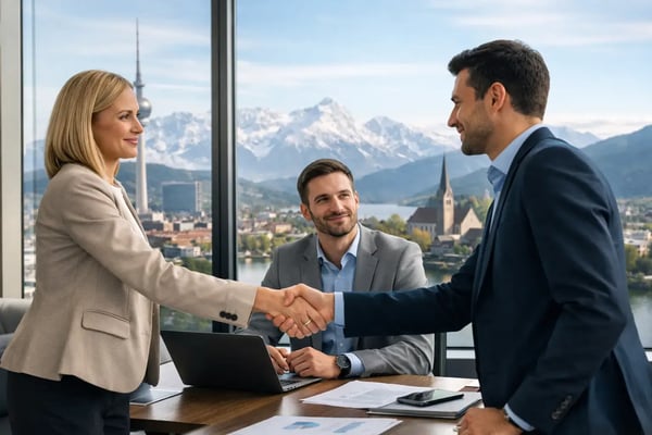 Expert staffing in the DACH region: Handshake at a table with an alpine view