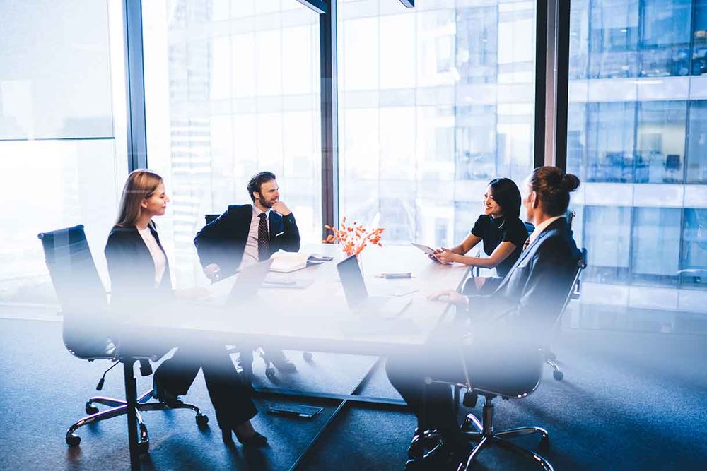 Advisers discussing financing and capital structure at a conference table