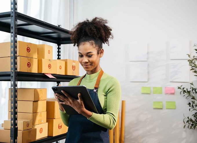 Retail employee recording stock levels with a tablet