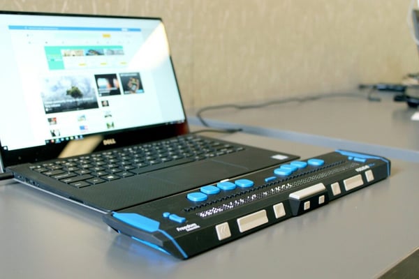 Accessible website: Laptop with a braille display in front of it