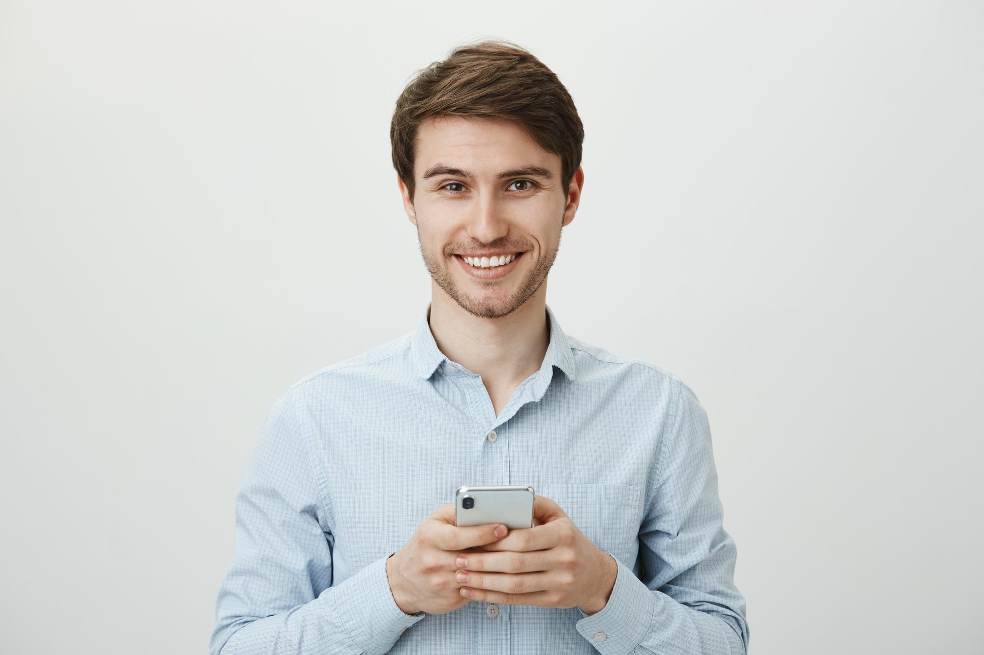 handsome-businessman-using-mobile-phone-smiling