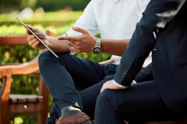 Consulting exit options: Two consultants talking over a tablet