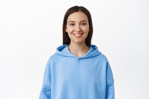 portrait-young-brunette-20s-woman-wearing-blue-hoodie-smiling-white-teeth-looking-happy-standing-against-white-background